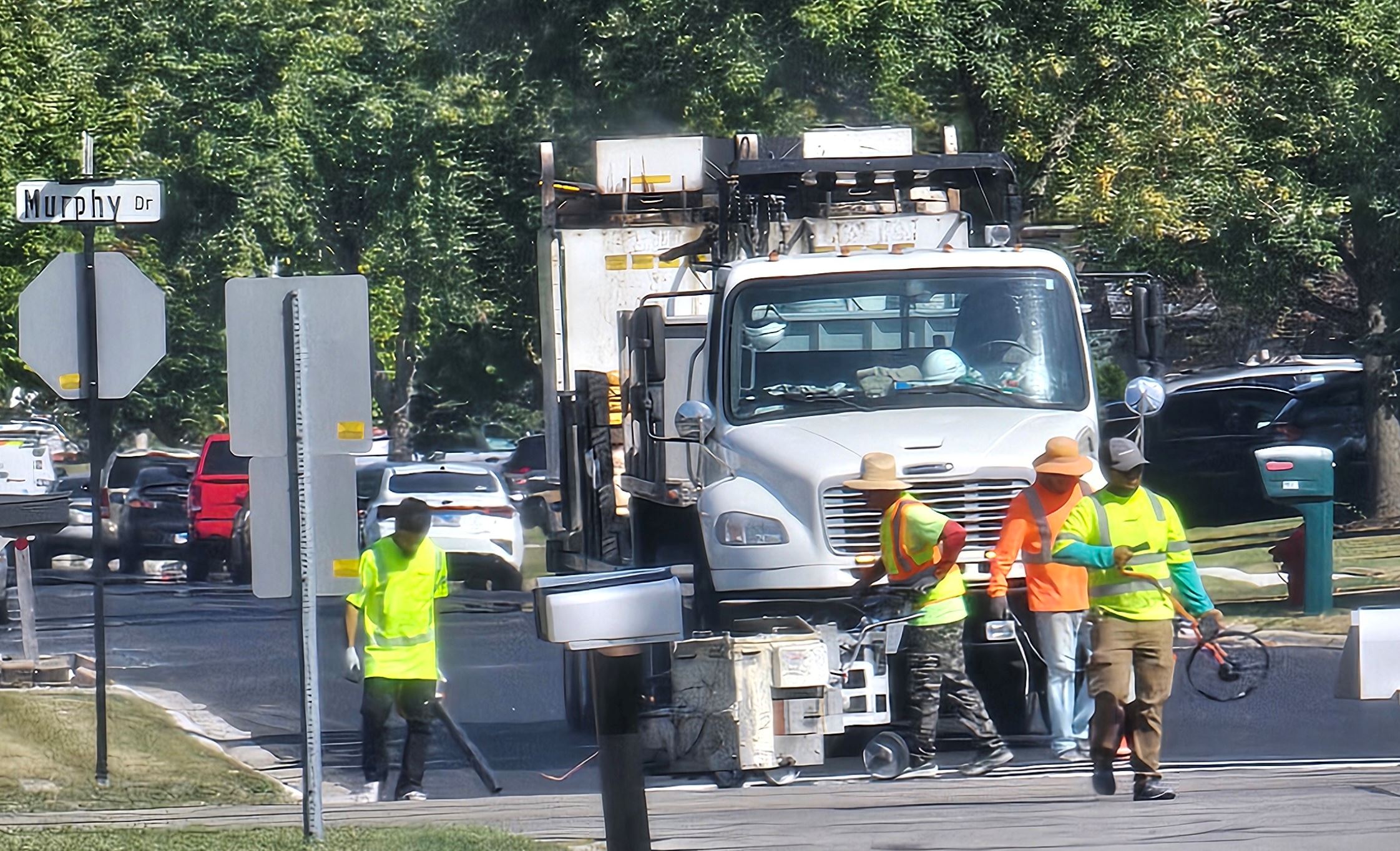 People walk in front of a truck.