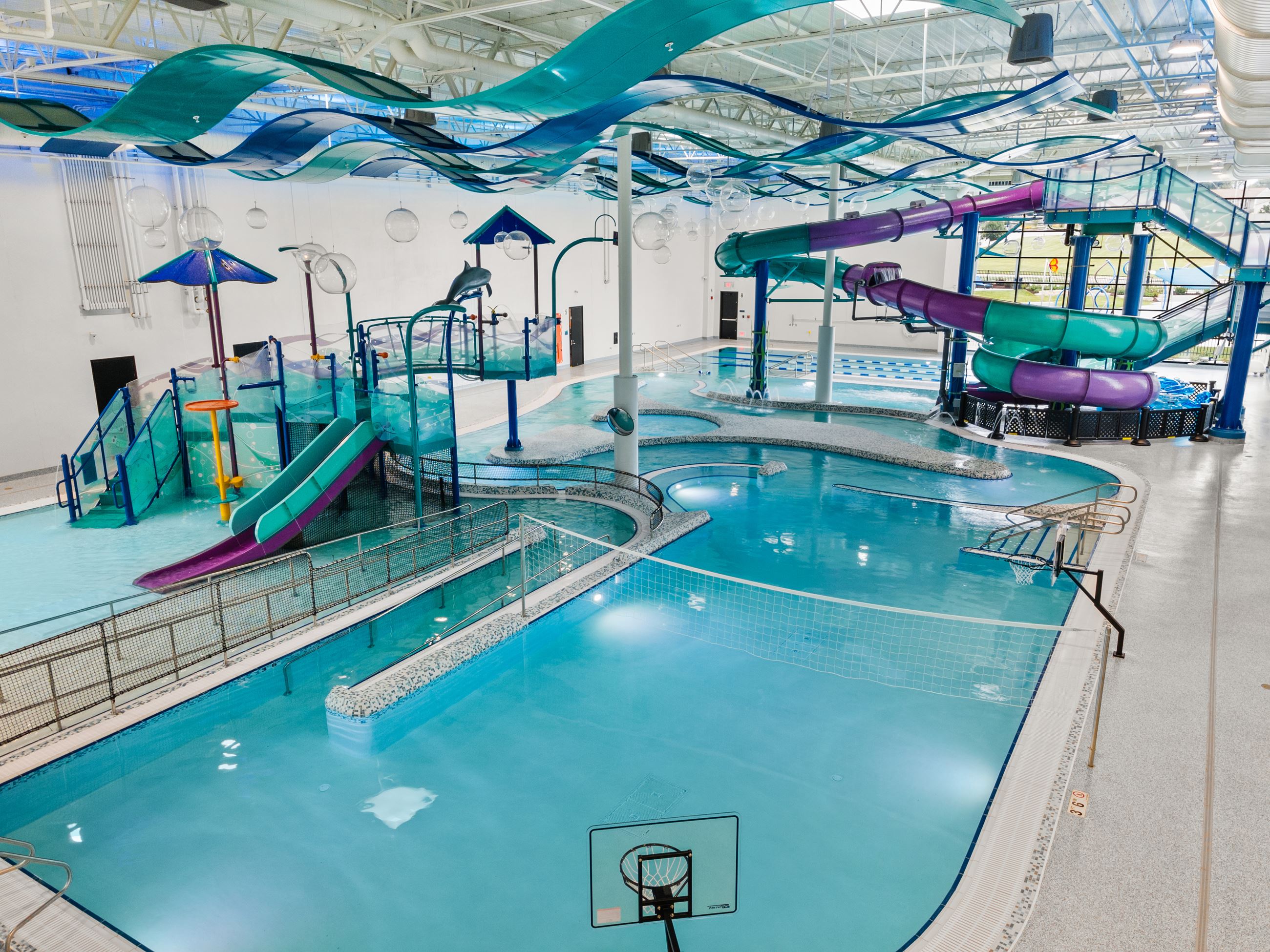 Pool, water slide, zero depth play area